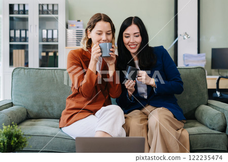 Female colleague caucasian descent holds a cup of coffee and talking discussion ideas and happily. 122235474