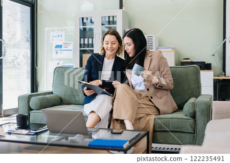 Diverse Business Team Discusses Financial Project Analysis in Meeting. Diverse Business Team Discusses Financial Project Analysis in Meeting. 122235491