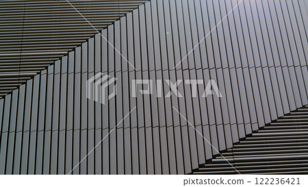 A Symmetry in Lines. Close-Up of a Contemporary Architectural Facade with Sleek Vertical Panels, Showcasing Modern Minimalism and Geometric Precision A Symmetry in Lines. Close-Up of a Contemporary Architectural Facade with Sleek Vertical Panels, Showcasing Modern Minimalism and Geometric Precision 122236421