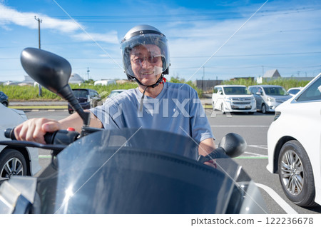 Senior men riding a motorcycle 122236678
