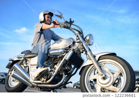 Senior men riding a motorcycle 122236681