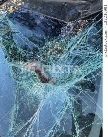 An Intricate Close Up View of Cracked Glass Featuring a Unique Spiderweb Pattern Design An Intricate Close Up View of Cracked Glass Featuring a Unique Spiderweb Pattern Design 122236991