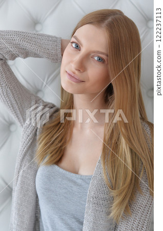 Beauty portrait. Young woman on grey wall background. Beauty portrait. Young woman on grey wall background. 122237113