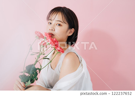 A young woman with flowers A young woman with flowers 122237652