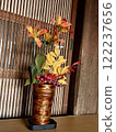 Flower arrangements displayed in an old house 122237656