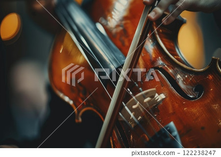Close-up of Hands Playing Violin with Bokeh Lights in the Background 122238247