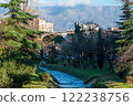 The Lana River with houses and mountains in the background, Tirana, Albania 122238756