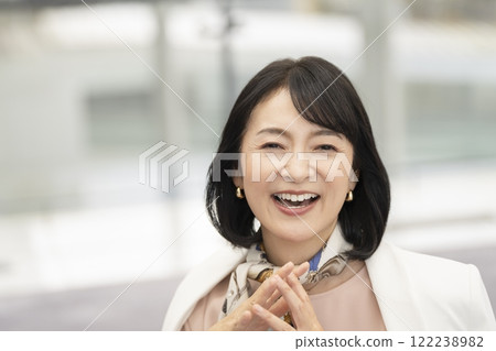 A woman in her 50s smiling at the camera 122238982