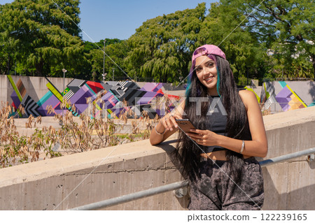 A smiling young millennial woman checking her cell phone messages 122239165