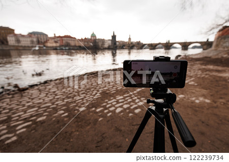 Smartphone recording time lapse of vltava river and charles bridge in prague Smartphone recording time lapse of vltava river and charles bridge in prague 122239734