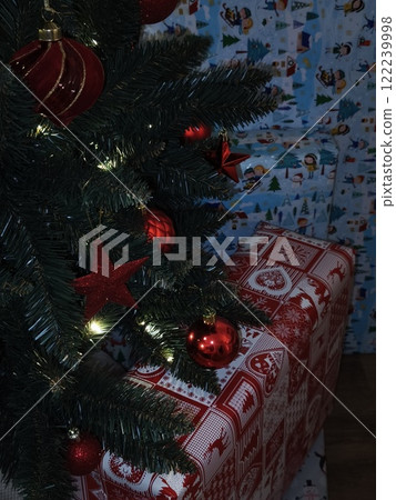 Christmas tree decorated with red ornaments and gifts in prague Gift boxes New Year preparation decor 122239998