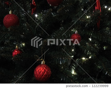 Christmas tree decorated with red ornaments and glowing lights in prague New Year preparation decor Christmas tree decorated with red ornaments and glowing lights in prague New Year preparation decor 122239999