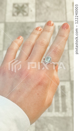 Woman showing aquamarine ring and soft skin of hand spa procedures on vacation in egypt 122240003
