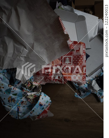 Christmas gift wrapping paper scattered on wooden floor in prague Christmas gift wrapping paper scattered on wooden floor in prague 122240013