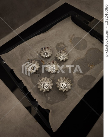 Baking tray with paper and muffin cases preparing for delicious treats 122240060