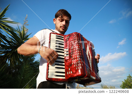 Virtuoso Accordionist Performing Amidst Nature 122240608