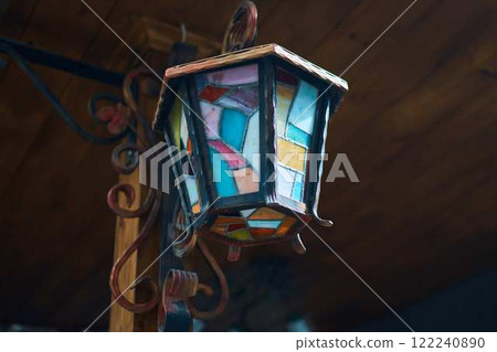 a multi-colored lantern made of metal and glass mosaic 122240890