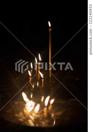 the wax candles are burning in the church 122240933