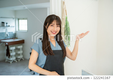 A Japanese female staff member providing guidance at the counter A Japanese female staff member providing guidance at the counter 122241167