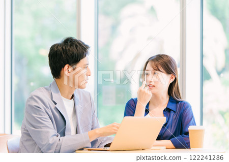 Young couple talking in a cafe Young couple talking in a cafe 122241286