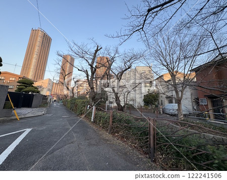 A riverside road surrounded by buildings A riverside road surrounded by buildings 122241506