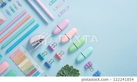 Stationery banner with pastel colored office supplies neatly laid out on light blue background. Place for your text. Stationery banner with pastel colored office supplies neatly laid out on light blue background. Place for your text. 122241854