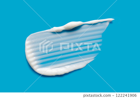 A sample of white cosmetic moisturizer on a blue background A sample of white cosmetic moisturizer on a blue background 122241906