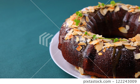 Beetroot chocolate bundt cake with fresh mint leaf. Tasty vegetarian dessert, breakfast or lunch. Delicious healthy pastry. Beetroot chocolate bundt cake with fresh mint leaf. Tasty vegetarian dessert, breakfast or lunch. Delicious healthy pastry. 122243009
