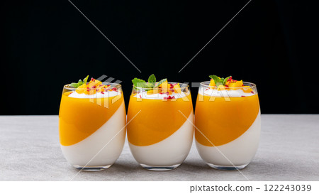 Tangerine panna cotta in a glass on the table Tangerine panna cotta in a glass on the table 122243039