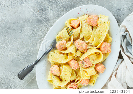 papardelle pasta, in creamy sauce with salmon, homemade, on a gray background, no people, papardelle pasta, in creamy sauce with salmon, homemade, on a gray background, no people, 122243104