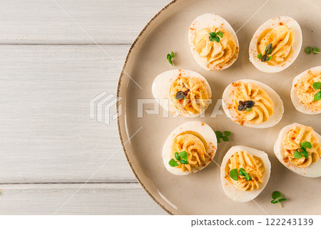 Boiled eggs stuffed with yolk with mayonnaise, on a white plate, selective focus, blurry, close-up, no people, Boiled eggs stuffed with yolk with mayonnaise, on a white plate, selective focus, blurry, close-up, no people, 122243139