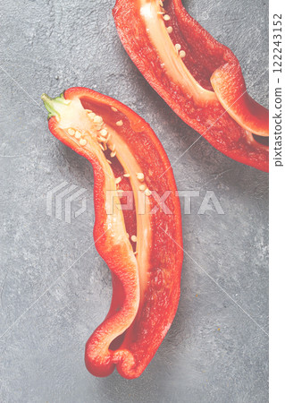 Sliced red peppers display vibrant color and fresh texture on a gray surface 122243152