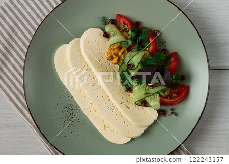 Sliced Imeruli cheese, Georgian cheese, with vegetables, top view, no people, Sliced Imeruli cheese, Georgian cheese, with vegetables, top view, no people, 122243157
