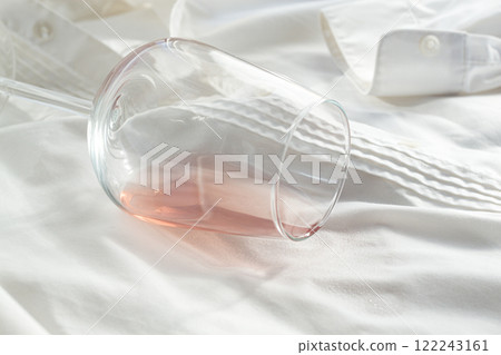 Glass, with pink wine, spilled on a white shirt, close-up, selective focus, no people, concept, top view, 122243161