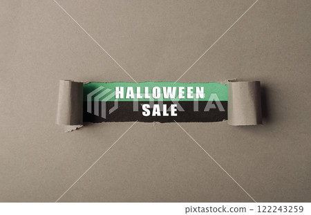 Sign for a Halloween sale is shown with a torn piece of paper Sign for a Halloween sale is shown with a torn piece of paper 122243259
