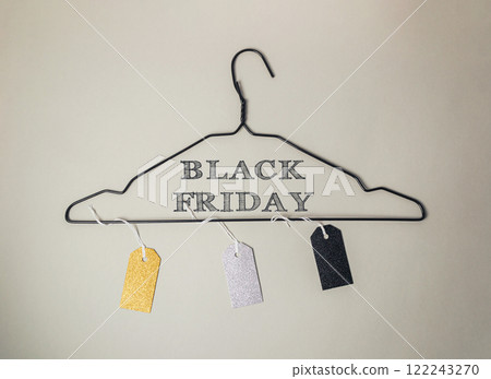 Black and white sign hanging from a clothes hanger that says Black Friday Black and white sign hanging from a clothes hanger that says Black Friday 122243270