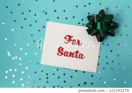 White card with red letters that says For Santa sits on a blue background wi White card with red letters that says For Santa sits on a blue background wi 122243279