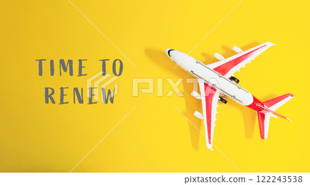 Small airplane is on a yellow background with the words Time to Renew Small airplane is on a yellow background with the words Time to Renew 122243538