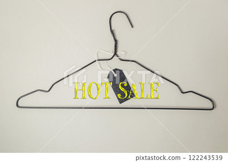 Clothes hanger with a tag that says hot sale on it 122243539