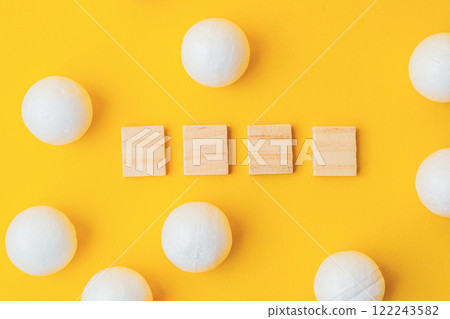 Wooden cubes with spheres on yellow background for minimalistic concept Wooden cubes with spheres on yellow background for minimalistic concept 122243582
