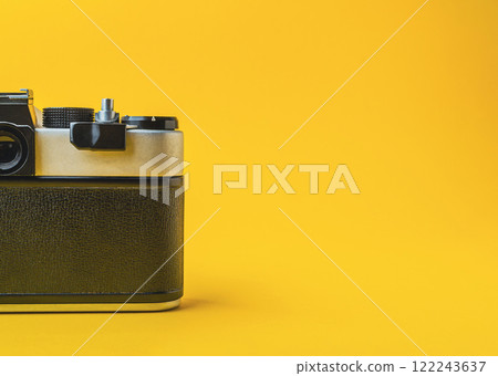 Retro camera on a yellow background with shadow play Retro camera on a yellow background with shadow play 122243637