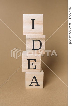Stacked wooden blocks with the word IDEA on a beige background Stacked wooden blocks with the word IDEA on a beige background 122243643