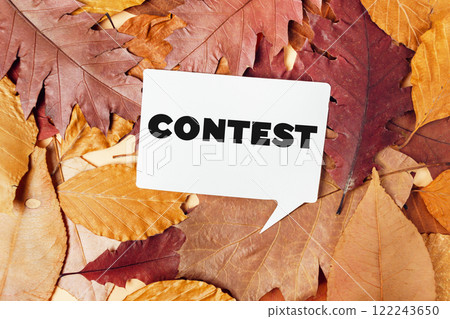 Autumn leaves with contest card and clock on a rustic background 122243650
