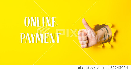 Hand with a thumbs up sign is in a yellow background Hand with a thumbs up sign is in a yellow background 122243654