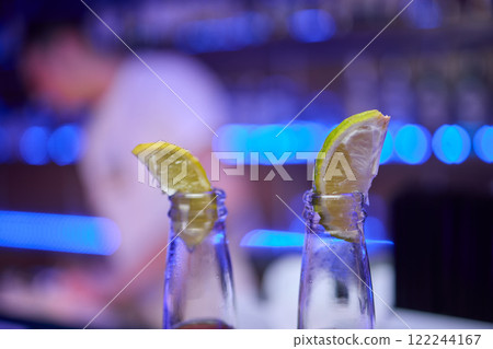 Enjoying Refreshing Beverages with Lime Slices in a Fun and Lively Social Setting Enjoying Refreshing Beverages with Lime Slices in a Fun and Lively Social Setting 122244167
