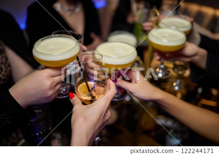 Cheers to a Fantastic Celebration Friends Joyfully Toasting with Wine Glasses in Hand 122244171