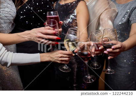 Cheers to a Fantastic Celebration Friends Joyfully Toasting with Wine Glasses in Hand 122244210