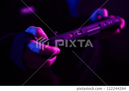 Enjoy an exciting gaming session with a handheld console full of thrills and adventures 122244264