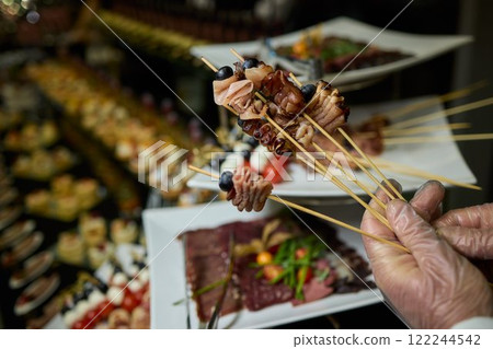 Indulge in Gourmet Skewers featuring a Diverse Selection of Delectable Delicacies at a Buffet Indulge in Gourmet Skewers featuring a Diverse Selection of Delectable Delicacies at a Buffet 122244542