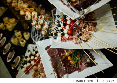 An Elegant Assortment of Gourmet Desserts and Savory Snacks Beautifully Arranged on Table 122244546